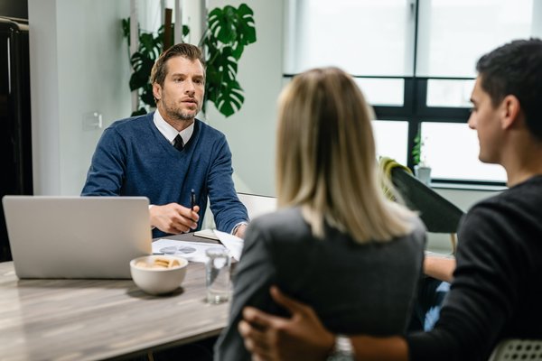 insurance agent having a meeting with a couple